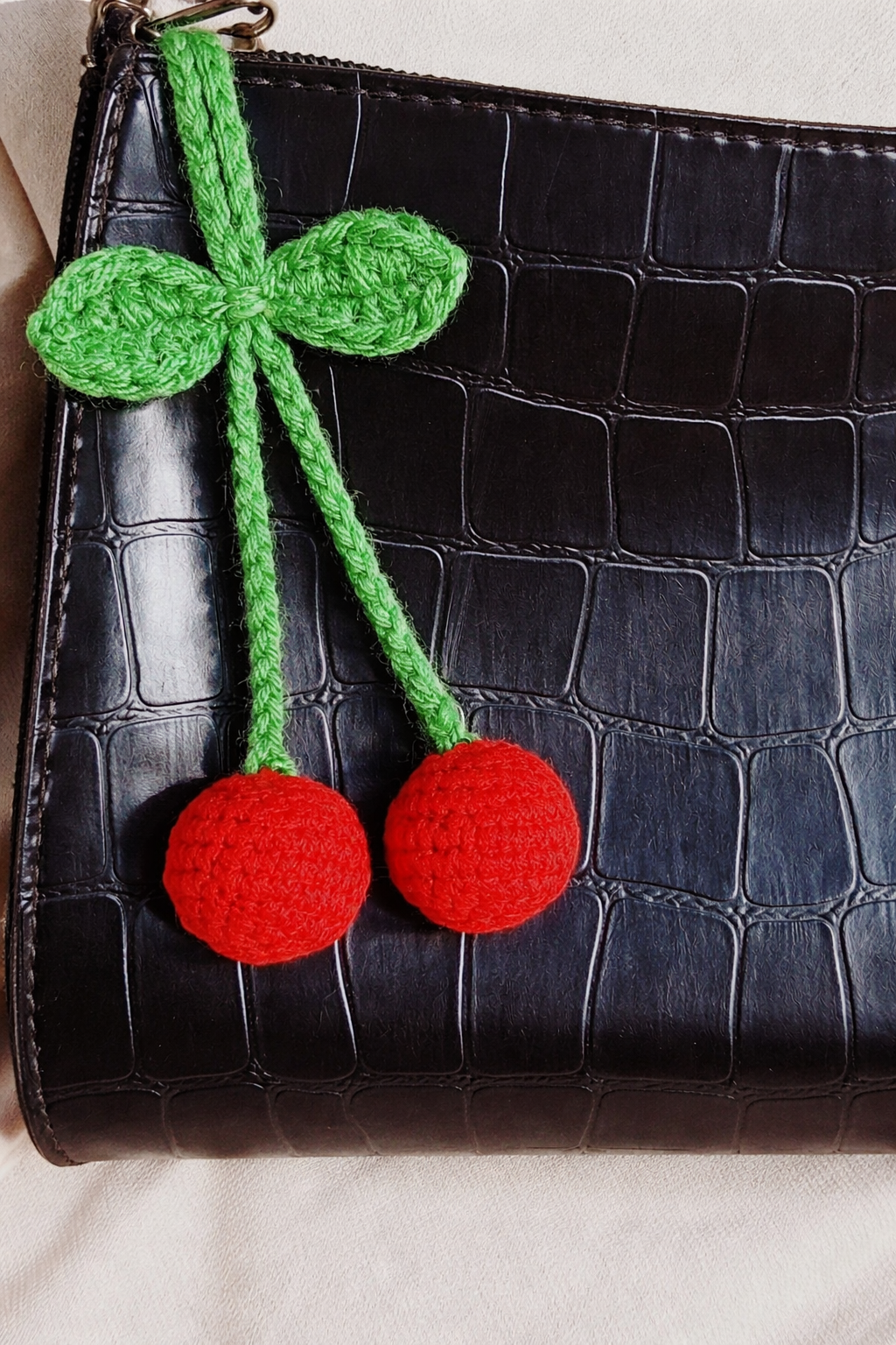 Handmade crochet cherry bag charm in red and green